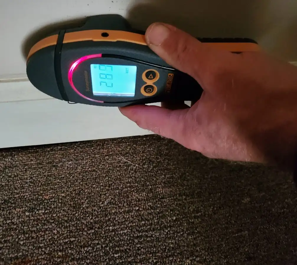 Moisture detection at baseboard during Storm Damage Restoration in Hebron